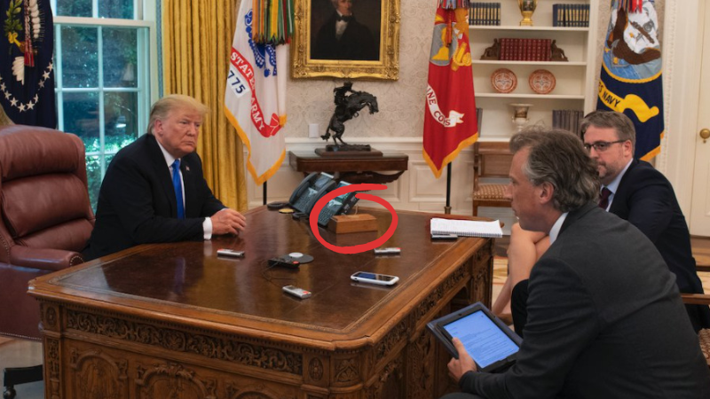 Trump'ın masasında küçük kahverengi bir tahta kutu varmış gibi görünüyor. (Diyet Kola Düğmesi)